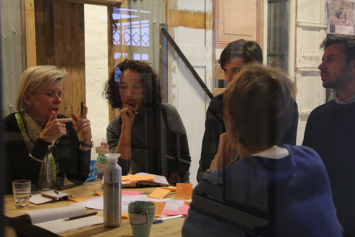 Image of Claire Bates and 4 colleagues at a table