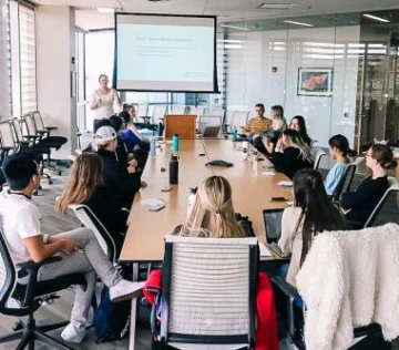 students at a conference table during a workshop